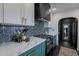 Modern kitchen featuring sleek white countertops, custom cabinets, and eye-catching backsplash at 541 W Palm Ln, Phoenix, AZ 85003