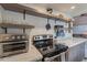 The kitchen features stainless steel appliances, marble counters, and floating shelves with decorative items at 541 W Palm Ln, Phoenix, AZ 85003