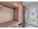 Modern laundry room with built-in storage, stacked washer-dryer, and outdoor access at 541 W Palm Ln, Phoenix, AZ 85003