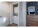 A compact laundry area featuring a stacked washer and dryer unit, complemented by a stylish accent wall at 541 W Palm Ln, Phoenix, AZ 85003