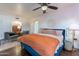 Bright main bedroom featuring a ceiling fan, hardwood floors, and comfortable seating area at 541 W Palm Ln, Phoenix, AZ 85003