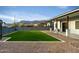 Spacious backyard featuring lush artificial turf and a desert landscape with a mountain view at 6244 S Flora Ln, Gold Canyon, AZ 85118