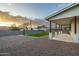 Beautiful backyard featuring gravel ground cover, grass area, and block wall providing privacy and security at 6244 S Flora Ln, Gold Canyon, AZ 85118