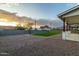 Beautiful backyard featuring gravel ground cover, grass area, and block wall providing privacy and security at 6244 S Flora Ln, Gold Canyon, AZ 85118