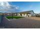 A beautiful backyard with a desert landscape, artificial turf, and a covered patio offering a relaxing outdoor space at 6244 S Flora Ln, Gold Canyon, AZ 85118