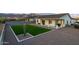 Beautiful backyard with artificial grass and desert landscaping offers a modern look with minimal upkeep at 6244 S Flora Ln, Gold Canyon, AZ 85118
