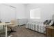 Well-lit bedroom with a neutral color scheme, featuring a desk and a closet at 6244 S Flora Ln, Gold Canyon, AZ 85118