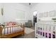 Bright bedroom with two beds, a glider chair, and walk-in closet at 6244 S Flora Ln, Gold Canyon, AZ 85118