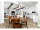 Open-concept dining area featuring wood floors, a fireplace, and seamless flow into kitchen at 6244 S Flora Ln, Gold Canyon, AZ 85118
