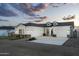 Stunning white home featuring a three car garage, stone accents, and beautiful curb appeal at 6244 S Flora Ln, Gold Canyon, AZ 85118