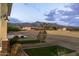 Exterior view of front yard with xeriscaping and mountain view in the distance at 6244 S Flora Ln, Gold Canyon, AZ 85118