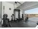 Home gym featuring workout equipment and mountain views from the open garage door at 6244 S Flora Ln, Gold Canyon, AZ 85118
