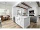 Bright open-concept kitchen featuring an island with a farmhouse sink and views of the living room at 6244 S Flora Ln, Gold Canyon, AZ 85118