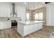 Island kitchen with quartz countertops, pendant lighting, and stainless steel appliances at 6244 S Flora Ln, Gold Canyon, AZ 85118