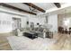 Bright open-concept living space with hardwood floors, exposed beams, and a large comfortable sectional at 6244 S Flora Ln, Gold Canyon, AZ 85118