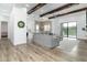 Bright living room with modern decor, wood beam ceiling, and an adjacent open kitchen at 6244 S Flora Ln, Gold Canyon, AZ 85118