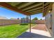 View of the backyard with green grass and a trampoline at 6413 W Monte Cristo Ave, Glendale, AZ 85306