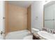 Bright bathroom with tub/shower combo, single sink vanity and tiled accents at 6413 W Monte Cristo Ave, Glendale, AZ 85306