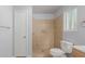 Bathroom with tiled shower, toilet, towel bar and a window for natural light at 6413 W Monte Cristo Ave, Glendale, AZ 85306