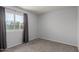 Cozy bedroom with neutral carpet, curtains and natural light streaming through the window at 6413 W Monte Cristo Ave, Glendale, AZ 85306