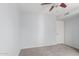 Neutral bedroom featuring a ceiling fan, window, closet and gray carpet at 6413 W Monte Cristo Ave, Glendale, AZ 85306