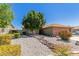 Single-story home with a desert front yard, rock water feature, and brick accents on the garage at 6413 W Monte Cristo Ave, Glendale, AZ 85306
