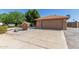 Well-maintained single-story home with a desert landscape and long driveway leading to a two-car garage at 6413 W Monte Cristo Ave, Glendale, AZ 85306