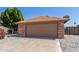 Two car garage featuring brick accents and an extra long driveway at 6413 W Monte Cristo Ave, Glendale, AZ 85306