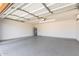 Spacious two car garage featuring epoxy flooring, a water heater and garage door opener at 6413 W Monte Cristo Ave, Glendale, AZ 85306