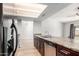 Kitchen features stainless steel appliances, wooden cabinets, and open floor plan at 6413 W Monte Cristo Ave, Glendale, AZ 85306