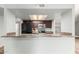 Kitchen featuring dark cabinets, stainless steel appliances, and a breakfast bar at 6413 W Monte Cristo Ave, Glendale, AZ 85306