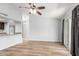 Open-concept living room features wood flooring, vaulted ceilings, and access to the kitchen at 6413 W Monte Cristo Ave, Glendale, AZ 85306