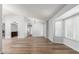 Open living space with hardwood floors, bay window, and a wet bar in the background at 6413 W Monte Cristo Ave, Glendale, AZ 85306