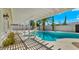 Inviting backyard pool area with white pergola, lush landscaping, and lounge chairs for relaxation at 6833 E Grandview Dr, Scottsdale, AZ 85254