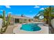 Beautiful backyard featuring a sparkling pool, patio area, desert landscaping, and sunny skies at 6833 E Grandview Dr, Scottsdale, AZ 85254