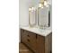 Bathroom featuring a double sink vanity with quartz countertops and modern fixtures at 6833 E Grandview Dr, Scottsdale, AZ 85254