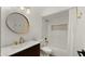 Well-lit bathroom with a modern vanity, round mirror, and subway-tiled shower-tub combo at 6833 E Grandview Dr, Scottsdale, AZ 85254