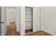 Bright bedroom closet featuring sliding doors and built-in shelving for optimal storage solutions at 6833 E Grandview Dr, Scottsdale, AZ 85254
