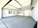 Spacious garage with epoxy flooring, bright lighting, and ample storage solutions, including shelving at 6833 E Grandview Dr, Scottsdale, AZ 85254