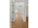 Bright hallway featuring wood-look floors leading to a spacious room with high ceilings and modern ceiling fan at 6833 E Grandview Dr, Scottsdale, AZ 85254