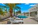 Backyard featuring a refreshing pool, lounge chairs, and desert landscaping with a palm tree at 6833 E Grandview Dr, Scottsdale, AZ 85254