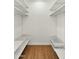 Spacious walk-in closet featuring wood-look flooring and wire shelving at 6833 E Grandview Dr, Scottsdale, AZ 85254