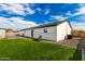 Expansive backyard features artificial turf, seating, and a well-maintained exterior of the home at 6908 W Wanda Lynn Ln, Peoria, AZ 85382