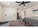 Neutral bedroom boasts carpeted floor, ceiling fan, double door closet, and a door to the hallway at 6908 W Wanda Lynn Ln, Peoria, AZ 85382