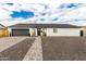 Charming single-story home with a gray garage door, manicured landscaping, and a paved walkway at 6908 W Wanda Lynn Ln, Peoria, AZ 85382