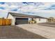 Modern home featuring a gray garage door, light stucco exterior, and well-maintained landscaping at 6908 W Wanda Lynn Ln, Peoria, AZ 85382