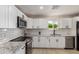 A bright kitchen showcasing white cabinets, stainless appliances, and granite counters at 6908 W Wanda Lynn Ln, Peoria, AZ 85382