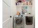 Clean laundry room featuring a front load washer/dryer and shelving at 6908 W Wanda Lynn Ln, Peoria, AZ 85382