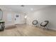 Bright, open living room with neutral walls, light wood-look floors, and contemporary decor at 6908 W Wanda Lynn Ln, Peoria, AZ 85382