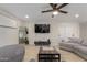 Comfortable living room featuring a large television, modern furniture, and an open layout at 6908 W Wanda Lynn Ln, Peoria, AZ 85382